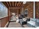 Relaxing screened porch with wicker furniture and ceiling fan at 6813 Search Light Trl, Lithonia, GA 30038