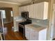 Kitchen with white cabinets, stainless steel appliances, and mosaic backsplash at 800 Crestside Ct # 800, Austell, GA 30168