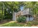 Gray house with a deck and stairs leading to the backyard, nestled among trees at 1010 Shepherds Ne Ln, Atlanta, GA 30324