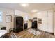 Galley kitchen with white cabinets and black appliances at 1433 Sunnybrook Dr, Jonesboro, GA 30236