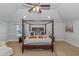 Main bedroom with a large four poster bed and ceiling fan at 4580 Cloister Cir, Hampton, GA 30228