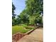 Landscaped yard with lush greenery and trees at 5148 Pine Cliff Tarn, Acworth, GA 30102