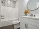 Bathroom with a patterned shower surround, white vanity, and black accents at 490 Third Ave, Scottdale, GA 30079