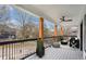 Relaxing porch with wooden posts, ceiling fan, and outdoor furniture at 490 Third Ave, Scottdale, GA 30079