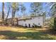 Rear view of house showcasing white brick exterior and landscaping at 996 Longleaf Dr, Forest Park, GA 30297