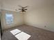 Bright bedroom with ceiling fan, carpet, and a window at 1325 Yorkshire Ln, Woodstock, GA 30188