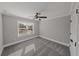 Spacious bedroom with ceiling fan and grey carpeting at 2450 China Berry Ln, Powder Springs, GA 30127