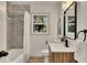 Updated bathroom with gray tile, a bathtub and modern vanity at 2718 Pine Grove Ct, Austell, GA 30106