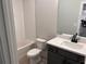 Clean bathroom with a white tub, toilet, and dark vanity at 2723 Byess Ct, Marietta, GA 30064