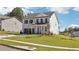 Two story house with gray roof, white and brick facade, and a two-car garage at 5391 Heron Bay Blvd, Locust Grove, GA 30248