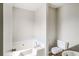 Clean bathroom with corner bathtub and granite vanity at 9343 Haley Ct, Jonesboro, GA 30238