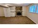 Spacious basement with fireplace and built-in shelving at 3277 Adelade Ct, Lithonia, GA 30038