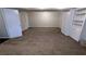 Finished basement with neutral carpeting and ample storage at 3277 Adelade Ct, Lithonia, GA 30038