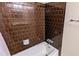 Brown tiled bathtub and shower combination at 3277 Adelade Ct, Lithonia, GA 30038