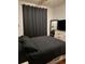 Spacious bedroom with a large bed and dark curtains at 870 Mayson Turner Nw Rd # 1110, Atlanta, GA 30314