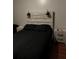 Bedroom with a wooden headboard and black bedding at 870 Mayson Turner Nw Rd # 1110, Atlanta, GA 30314
