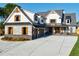 Two-story home with stone accents and a three-car garage at 1106 Flowers Dr, Cumming, GA 30041