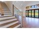 Elegant staircase with wood treads and a sleek metal railing at 1106 Flowers Dr, Cumming, GA 30041