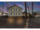 Two-story house with a covered porch, lit at dusk at 4158 Valley Sw Dr, Lilburn, GA 30047