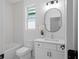 Modern bathroom with white vanity, hexagon tile, and oval mirror at 88 Cleveland Se St # B, Atlanta, GA 30316