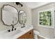 Modern bathroom with double vanity, large mirrors, and updated fixtures at 1886 S Hidden Hills Pkwy, Stone Mountain, GA 30088