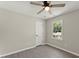 Simple bedroom with ceiling fan, wood-look floors, and a window at 1886 S Hidden Hills Pkwy, Stone Mountain, GA 30088