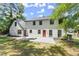 Updated home exterior, featuring a red door and white siding at 1886 S Hidden Hills Pkwy, Stone Mountain, GA 30088