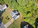 Aerial view of a house with a driveway and large backyard surrounded by trees at 3362 Eastmont Ln, Lithonia, GA 30038