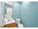 Small bathroom with light blue walls and wood vanity at 3362 Eastmont Ln, Lithonia, GA 30038