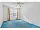 Spacious bedroom with blue carpet and large window at 3362 Eastmont Ln, Lithonia, GA 30038