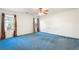 Primary bedroom with blue carpet and ceiling fan at 3362 Eastmont Ln, Lithonia, GA 30038