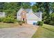 Two-story house with gray siding, brick accents, and a two-car garage at 3362 Eastmont Ln, Lithonia, GA 30038