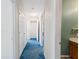 Hallway with blue carpet and multiple doors at 3362 Eastmont Ln, Lithonia, GA 30038