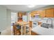 Galley style kitchen with wood cabinets and island at 3362 Eastmont Ln, Lithonia, GA 30038