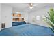 Living room with blue carpet, fireplace, and kitchen view at 3362 Eastmont Ln, Lithonia, GA 30038