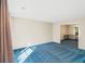 Bright living room features blue carpet and views into dining area at 3362 Eastmont Ln, Lithonia, GA 30038