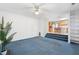 Living room with blue carpet, fireplace, and kitchen view at 3362 Eastmont Ln, Lithonia, GA 30038