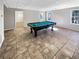 Basement game room with tile flooring and a pool table at 487 Skiles Ct, Suwanee, GA 30024