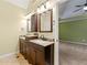 Double vanity bathroom with updated fixtures and neutral tile flooring at 509 First St, Lawrenceville, GA 30046