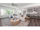 Spacious living room with L-shaped sofa and view into the kitchen at 628 Gilles Ln, Cumming, GA 30041