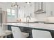 Sleek kitchen island with white quartz countertop and seating for three at 90 Cleveland Se St # A, Atlanta, GA 30316