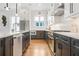 Open concept kitchen with dark gray cabinetry and hardwood floors at 90 Cleveland Se St # A, Atlanta, GA 30316