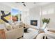 Living room with hardwood floors, a modern fireplace, and large windows at 90 Cleveland Se St # A, Atlanta, GA 30316