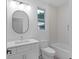 Modern bathroom with white vanity, oval mirror, and bathtub at 90 Cleveland Se St # B, Atlanta, GA 30316