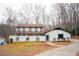 Two-story house with white brick, black trim, and a large front porch at 2085 High Point Sw Trl, Atlanta, GA 30331