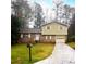 Brick and vinyl-sided house with attached garage and driveway at 3550 Leisure Ln, Atlanta, GA 30349
