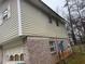 Tan vinyl siding with a brick base and attached garage at 3550 Leisure Ln, Atlanta, GA 30349