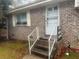 Brick front entrance with steps and white railings at 3550 Leisure Ln, Atlanta, GA 30349