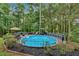 Round above-ground pool with a wooden deck at 17 Wexford Nw Cir, Cartersville, GA 30121