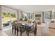 Dining area with a large table, sliding glass doors to the backyard, and hardwood floors at 5567 Rosehall Pl, Atlanta, GA 30349